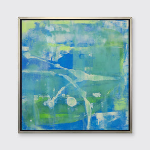 A blue, green and beige abstract print in a silver floater frame hangs on a white wall.