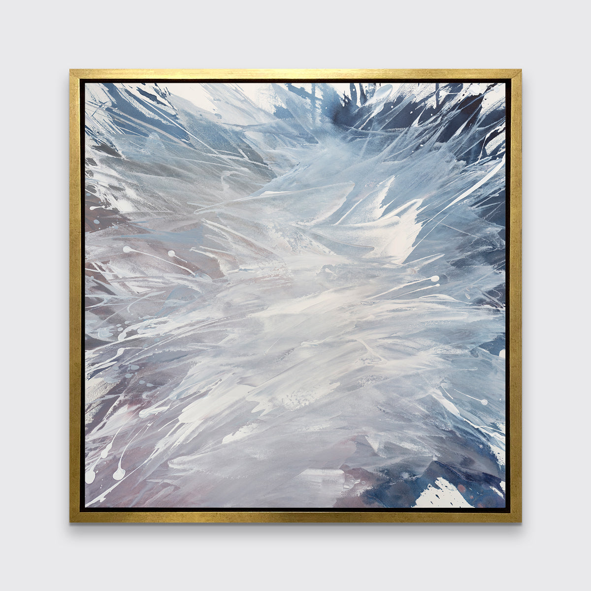 A light purple, grey, white and blue abstract print in a gold floater frame hangs on a white wall.