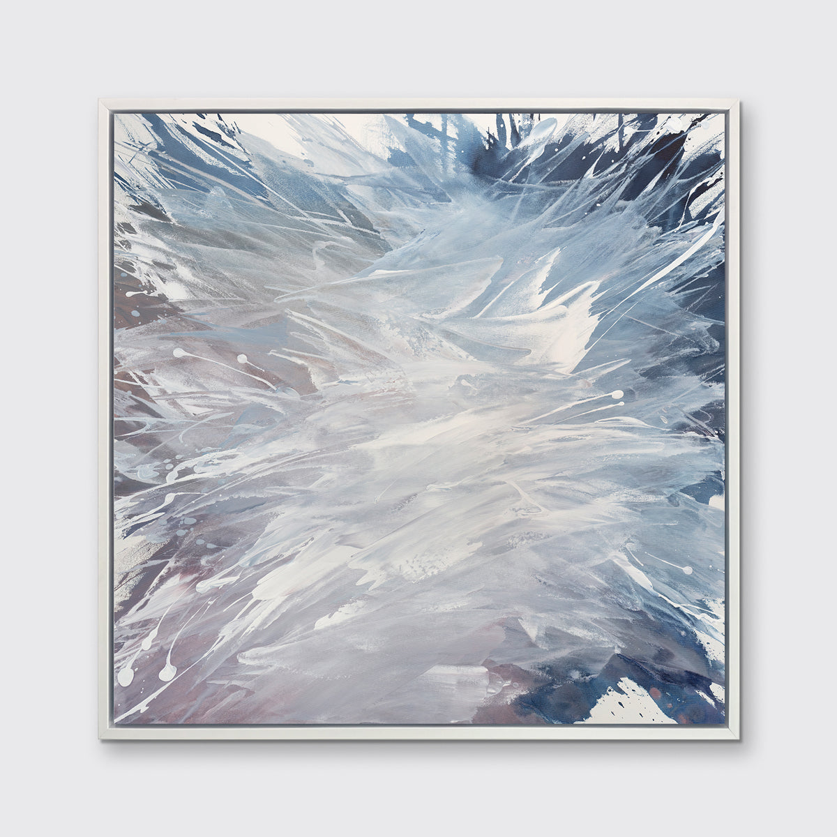 A light purple, grey, white and blue abstract print in a white floater frame hangs on a white wall.