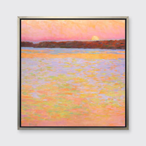 A pink, orange, lavender and red impressionist landscape print in a silver floater frame hangs on a white wall.