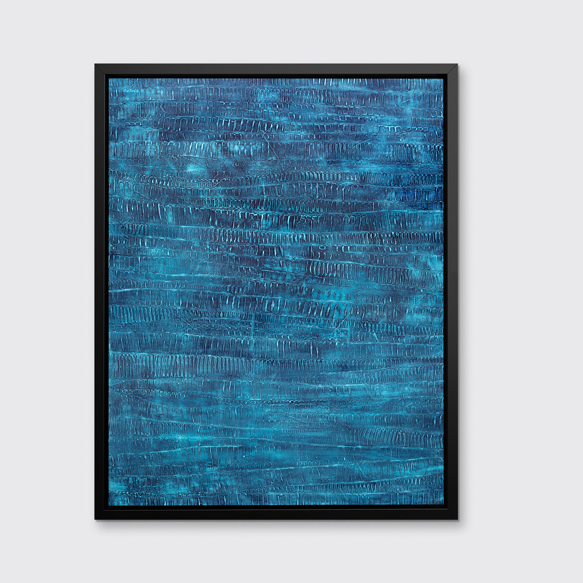 A dark teal abstract print in a black floater frame hangs on a white wall.