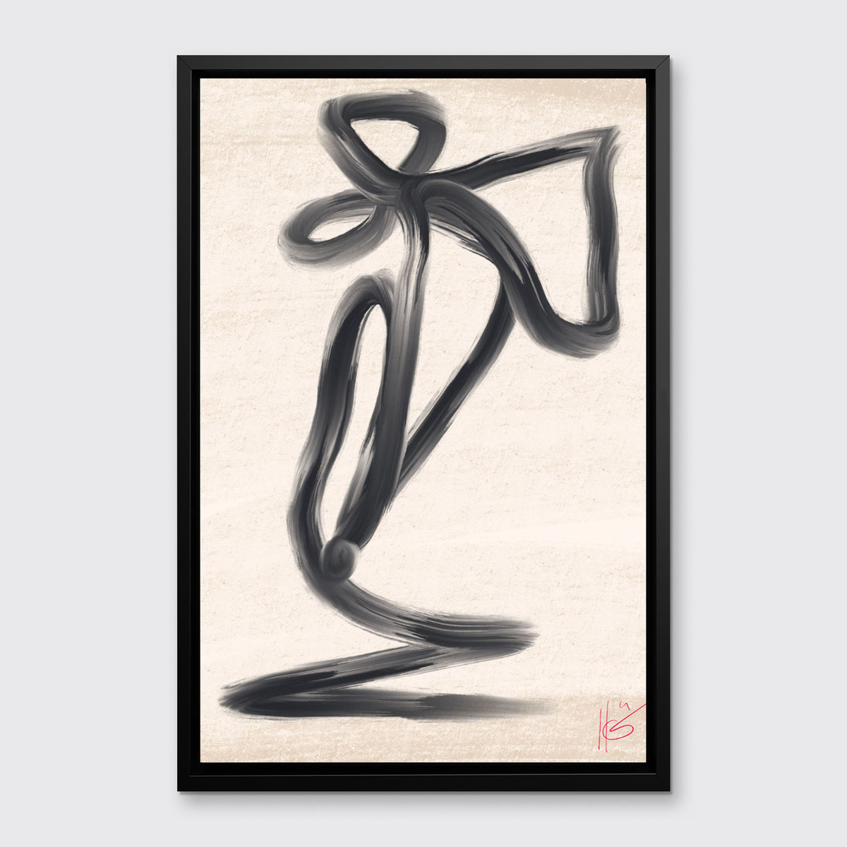 A black and beige abstract print framed in a black floater frame hangs on a light grey wall.