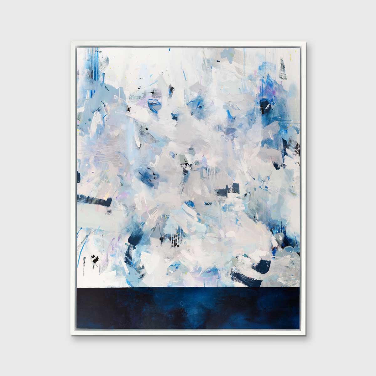 A blue, white and light grey abstract print in a white floater frame hangs vertically on a white wall.