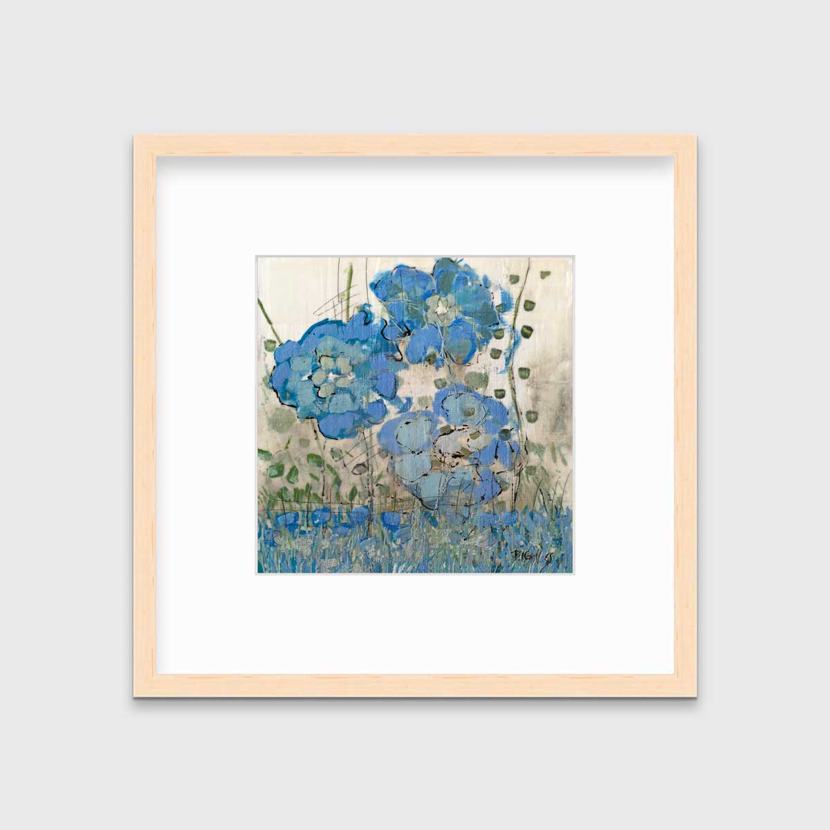 A blue floral print in a natural wood frame with a mat hangs on a white wall.