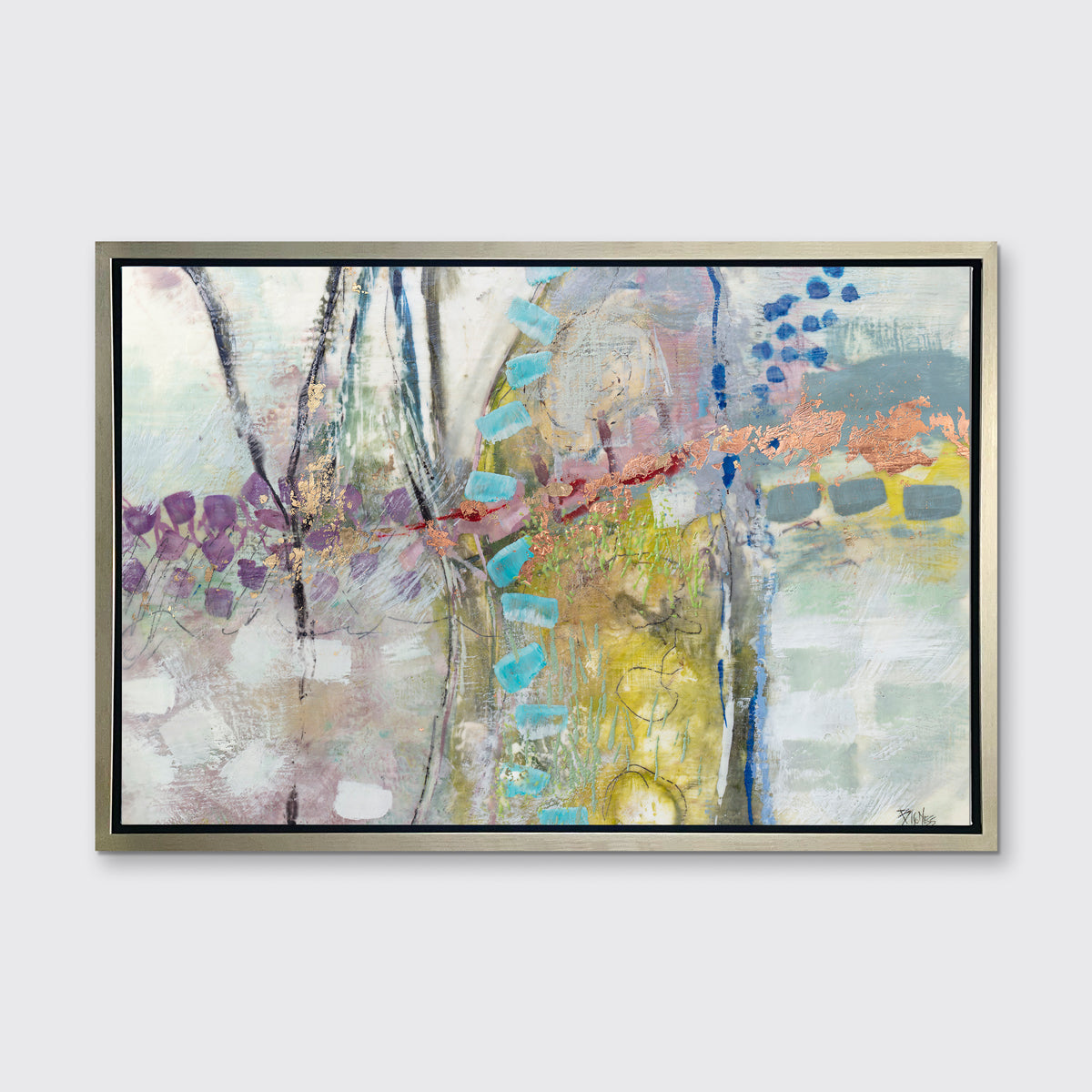 A multicolored abstract print in a silver floater frame hangs on a white wall.