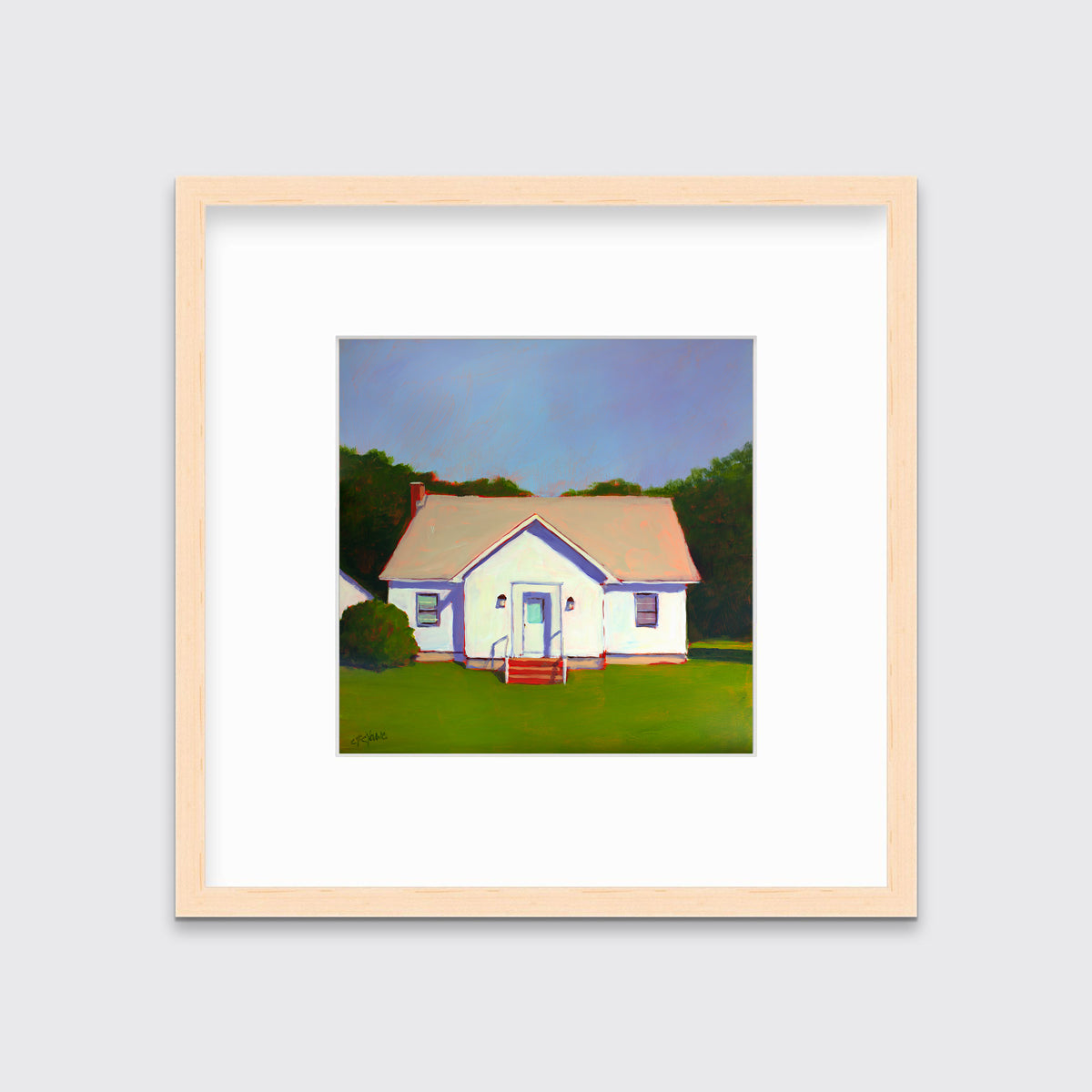 A blue, white and green contemporary house print in a natural wood frame with a mat hangs on a white wall.