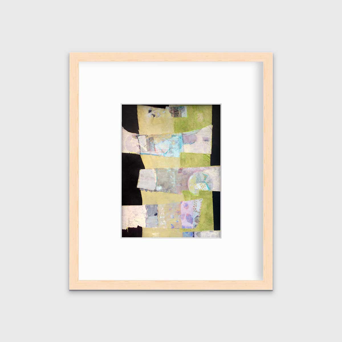 A green, black and beige abstract print by Christine Averill-Green in a natural wood frame with a mat hangs on a white wall.