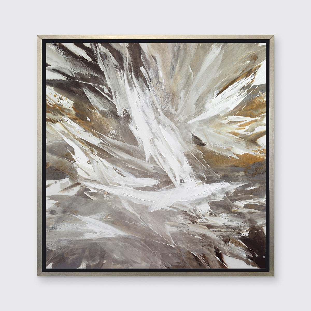 A white, grey, dark grey and gold abstract print in a silver floater frame hangs on a white wall.