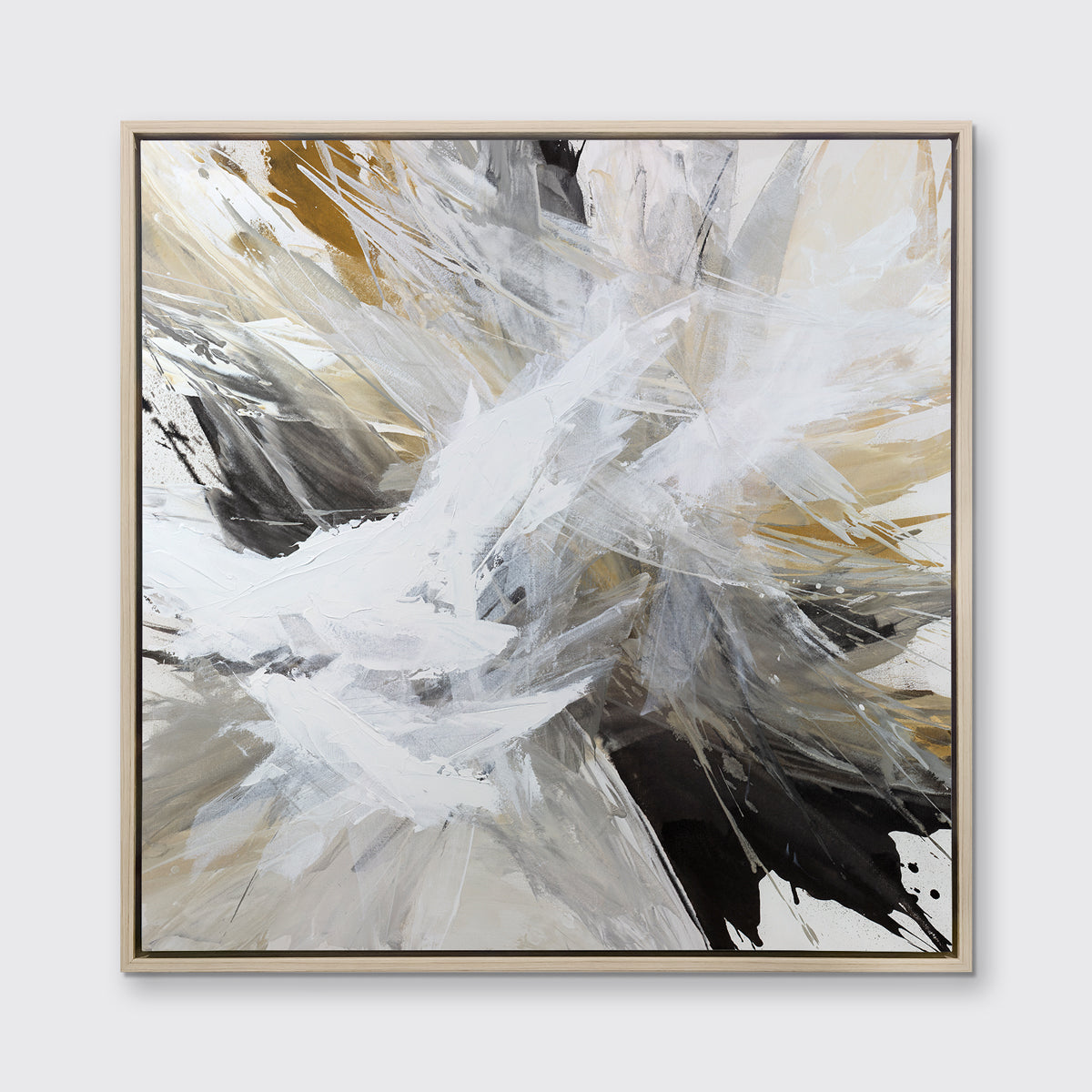 A white, black, grey and gold abstract print in a white oak wood floater frame hangs on a white wall.
