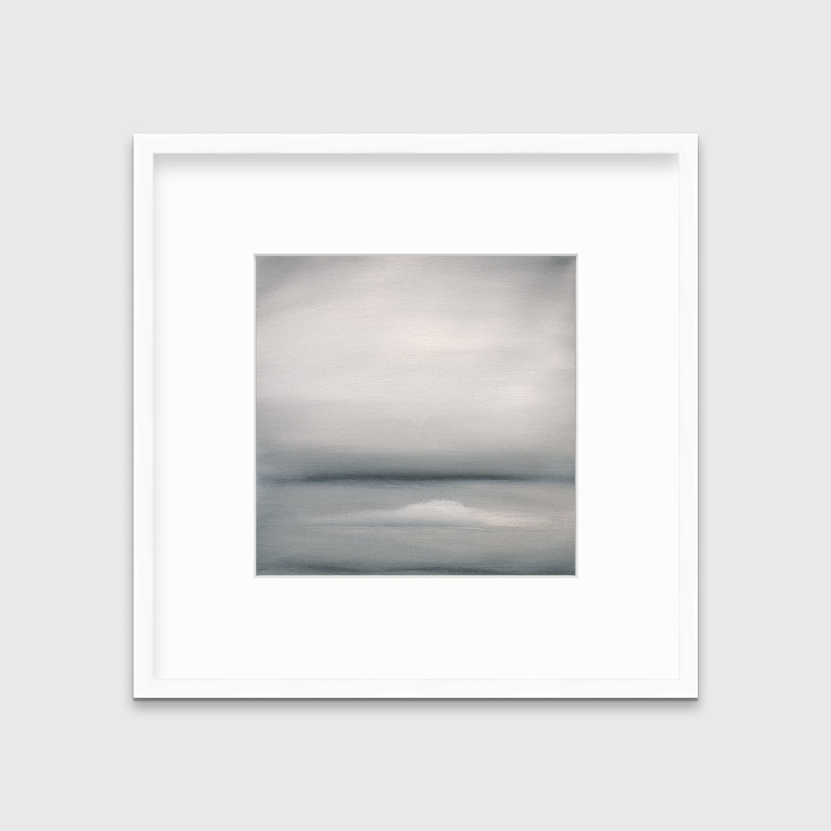 A tonal grey abstract print in a white frame with a mat hangs on a white wall.