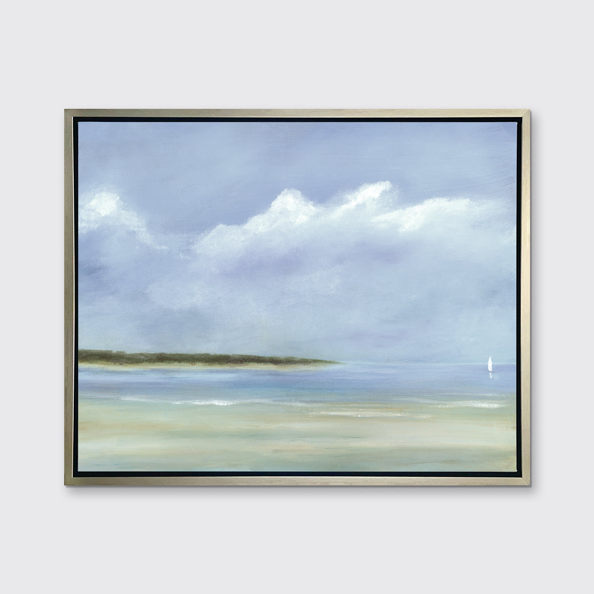 A blue, white and green seascape print in a silver floater frame hangs on a white wall.