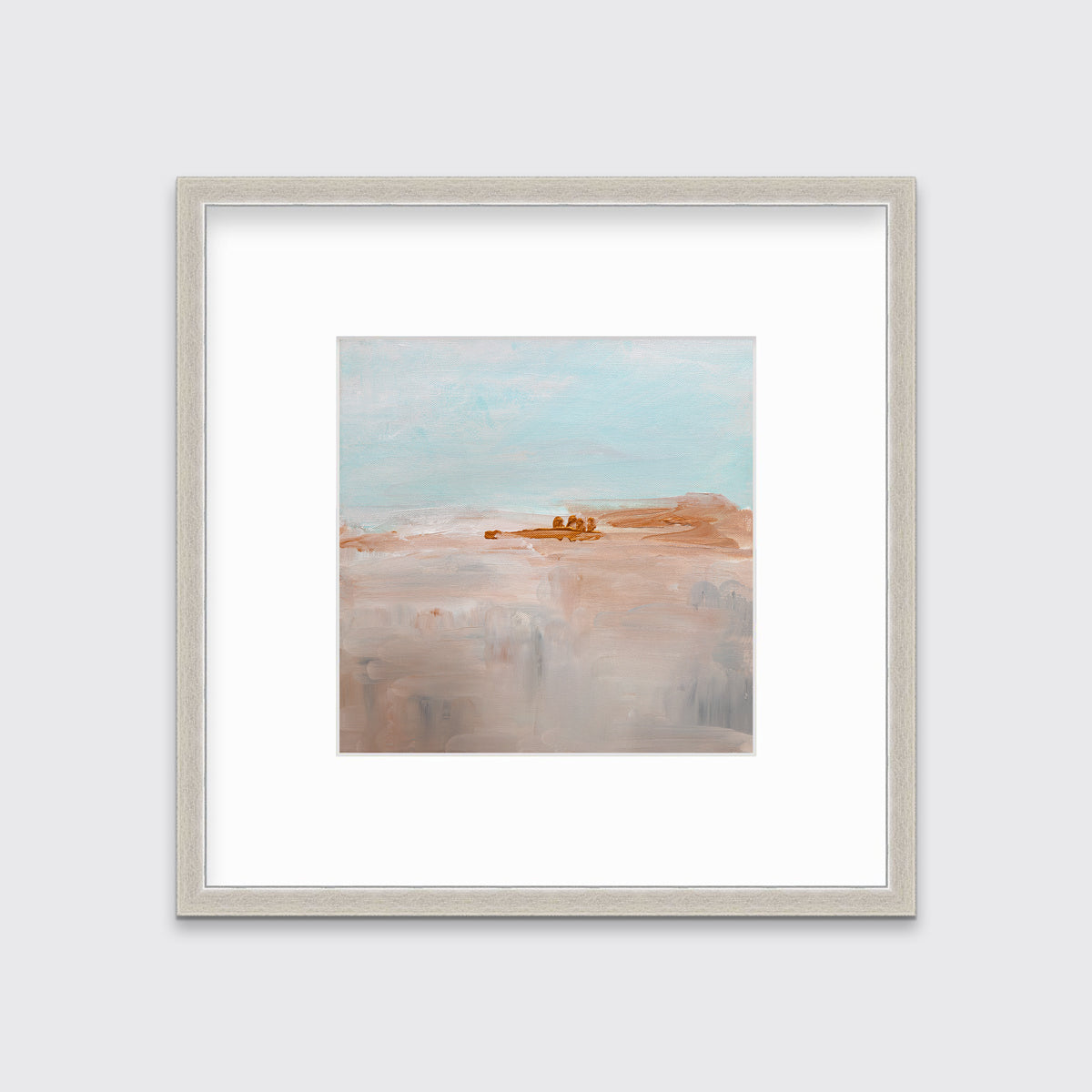 A teal, copper and dusty pink abstract print in a silver frame with a mat hangs on a white wall.