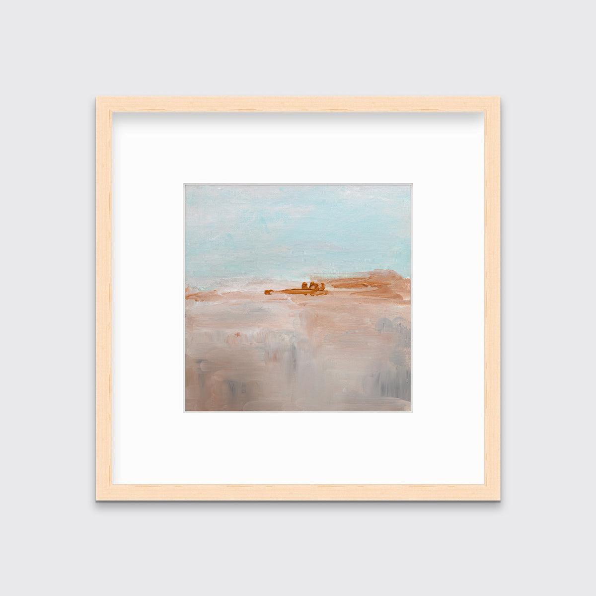 A teal, copper and dusty pink abstract print in a natural wood frame with a mat hangs on a white wall.