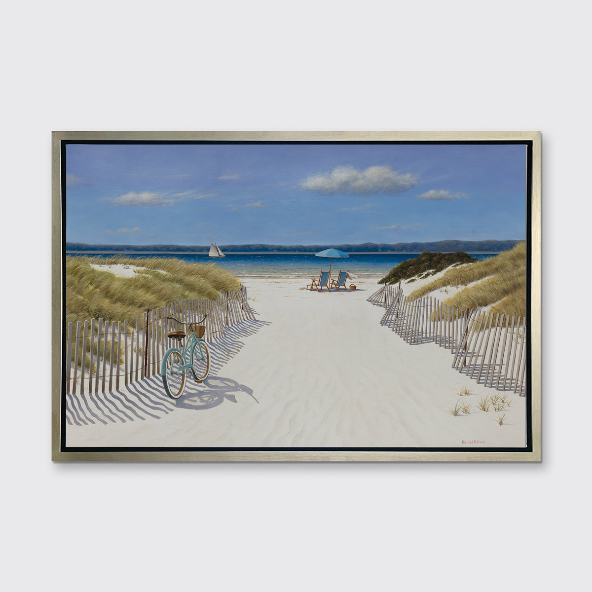 A blue, beige and light green contemporary seascape print in a silver floater frame hangs on a white wall.