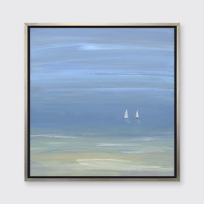 A blue, beige and white abstract seascape print with two small sailboats in a silver floater frame hangs on a white wall.