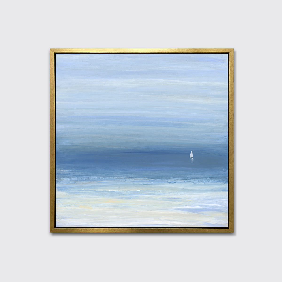 A blue, beige and white abstract seascape print with a small sailboat in a gold floater frame hangs on a white wall.