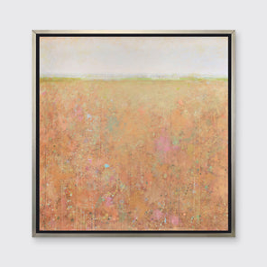A orange, light green, light blue and pink abstract landscape print in a silver floater frame hangs on a white wall.