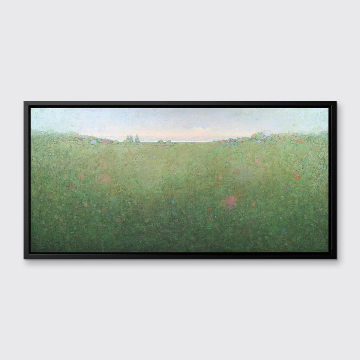 A green abstract landscape print in a black floater frame hangs on a white wall.