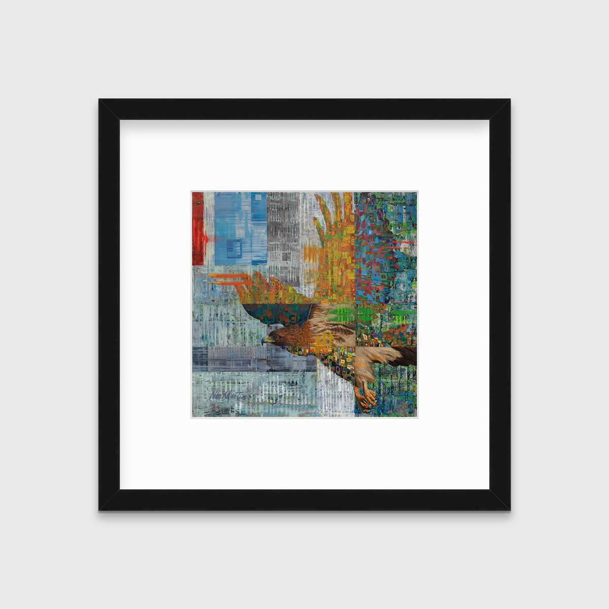 A multicolored abstract print of a flying eagle in a black frame with a mat hangs on a white wall.