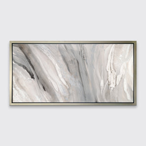 A beige, white and gold abstract print in a silver floater frame hangs on a white wall.