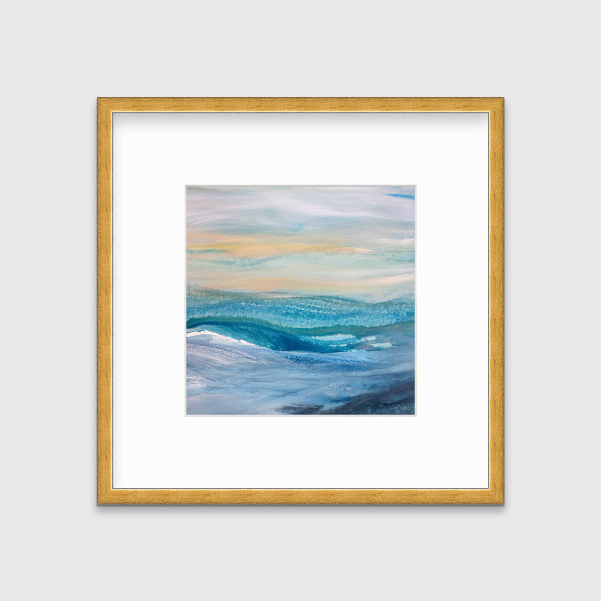 A blue, teal, yellow and white abstract print in a gold frame with a mat hangs on a white wall.