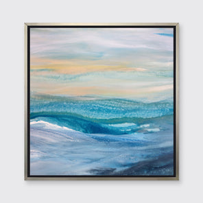 A blue, teal, yellow and white abstract print in a silver floater frame hangs on a white wall.