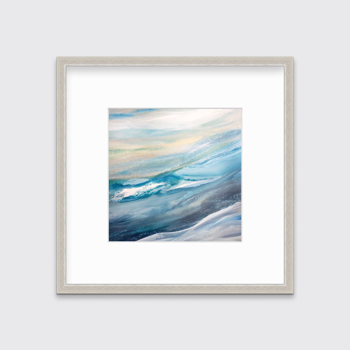 A blue, teal, yellow and white abstract print in a silver frame with a mat hangs on a white wall.