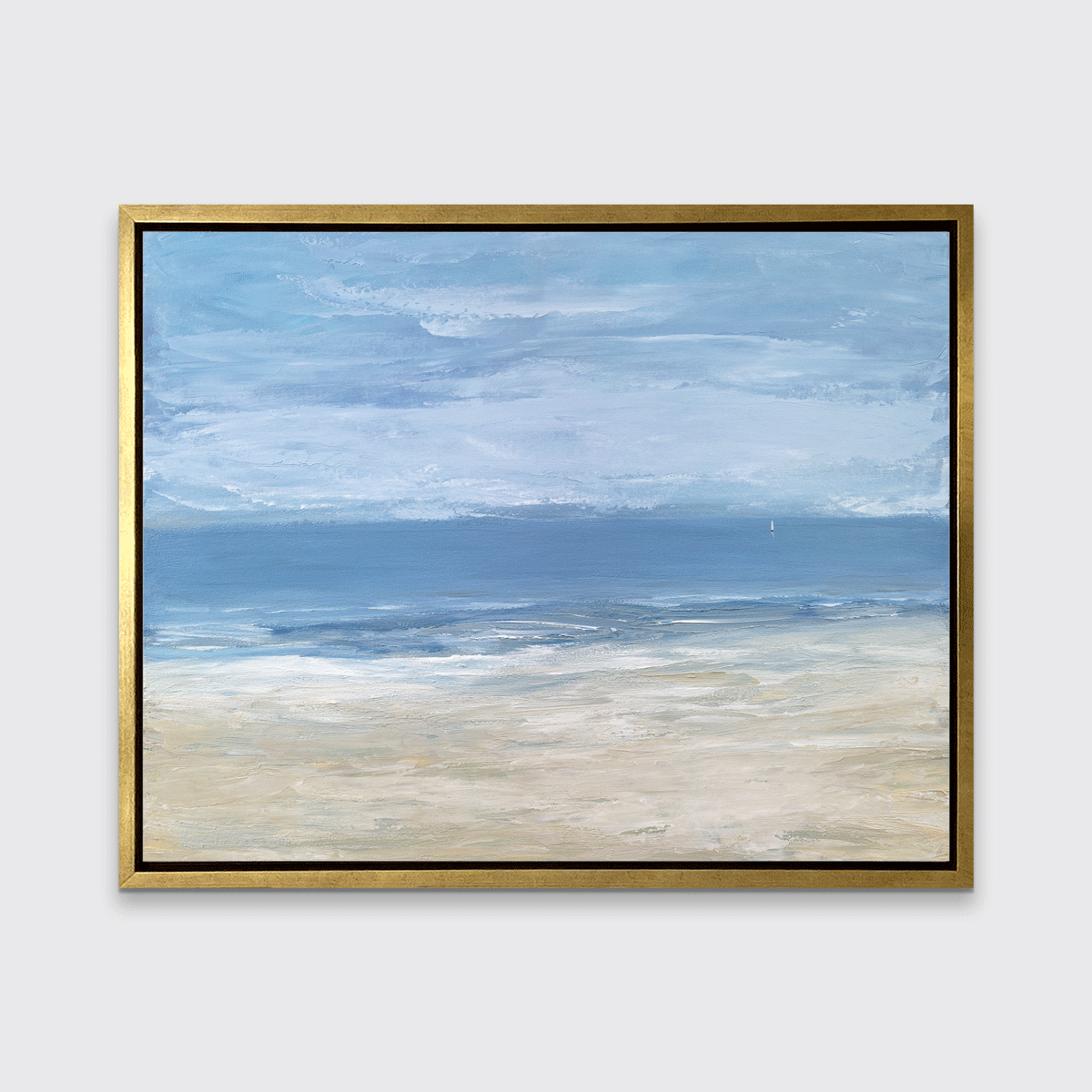 A blue, light blue, white and beige abstract seascape print in a gold floater frame hangs on a white wall.