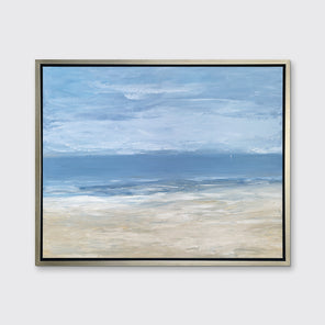 A blue, light blue, white and beige abstract seascape print in a silver floater frame hangs on a white wall.