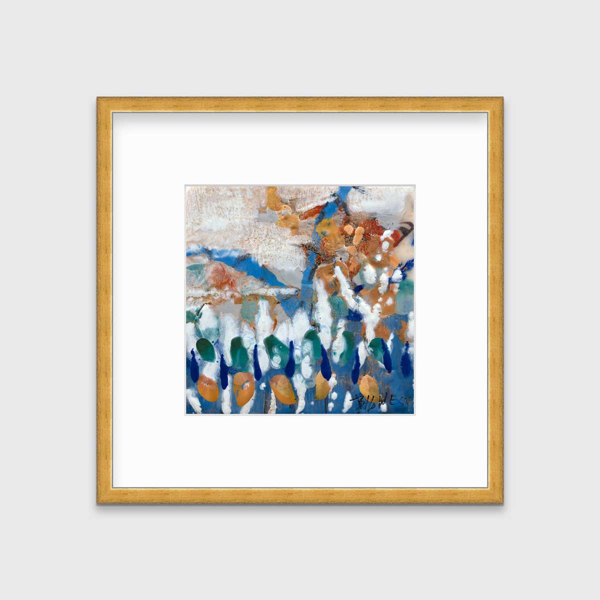 A multicolored abstract print in a gold frame with a mat hangs on a white wall.