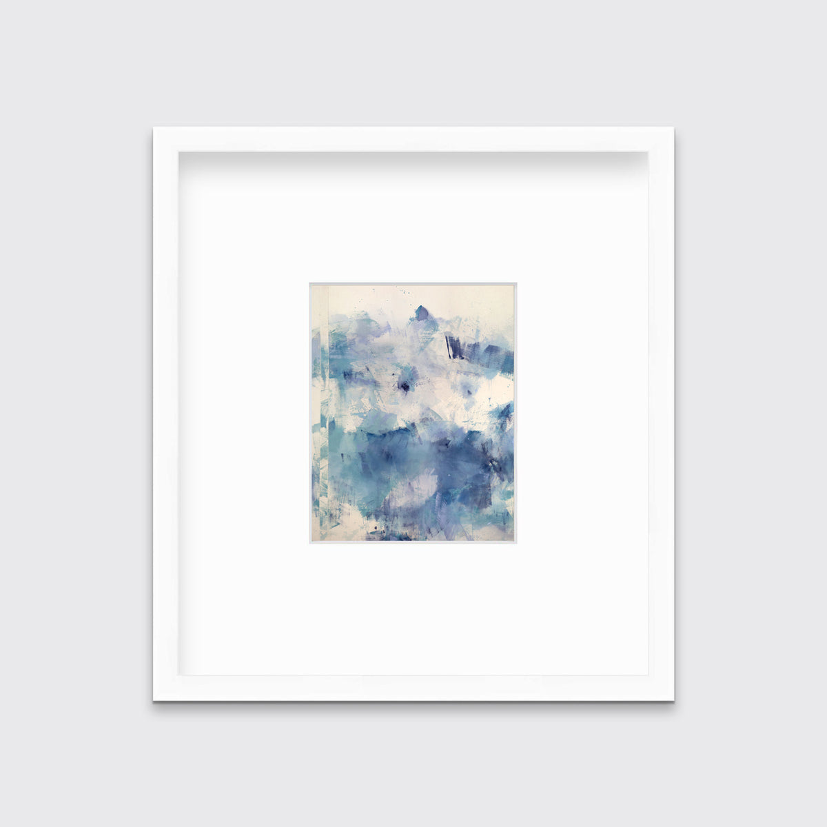 A blue abstract print matted and framed in a white frame hangs on a white wall.