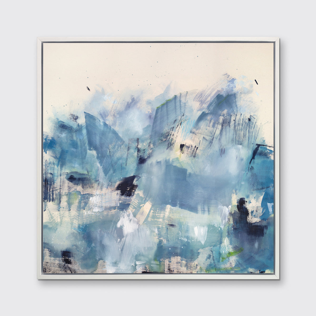 A blue and white abstract print framed in a white frame hangs on a white wall.