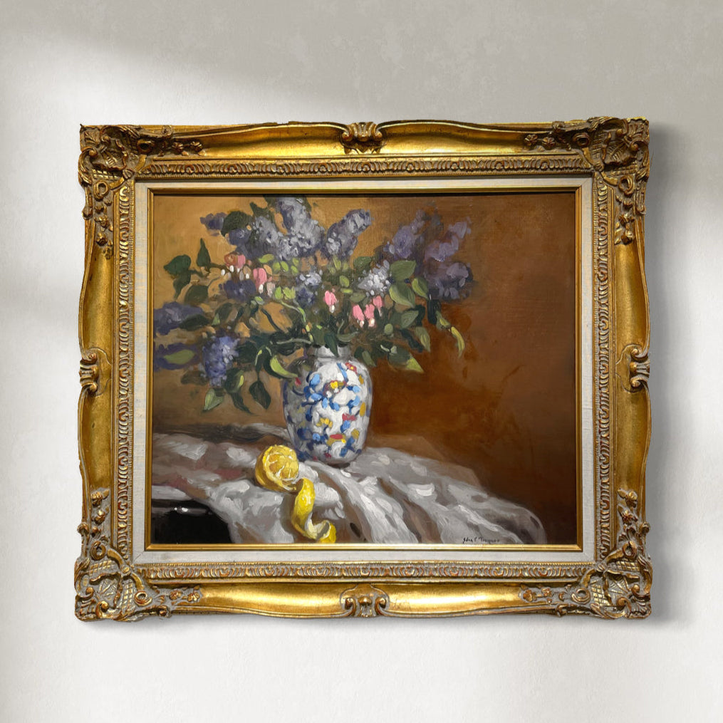 An original oil on canvas painting titled 'Lilacs' featuring a vase of lilacs with a floral pattern on the vase, set against a traditional wooden frame.