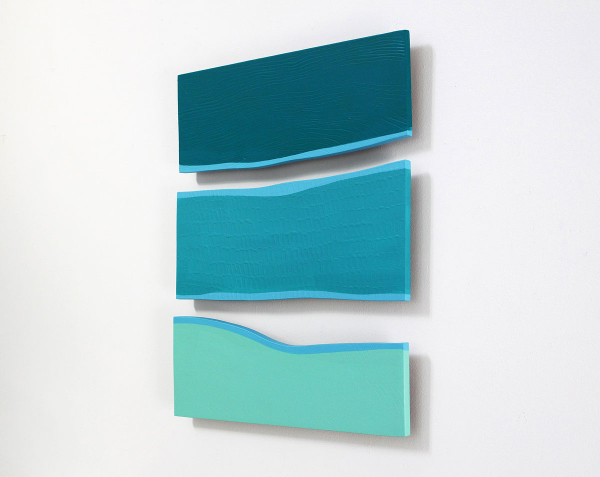 A square-shaped abstract artwork featuring overlapping panels of blue, green, and white colors, side view, on a white background.