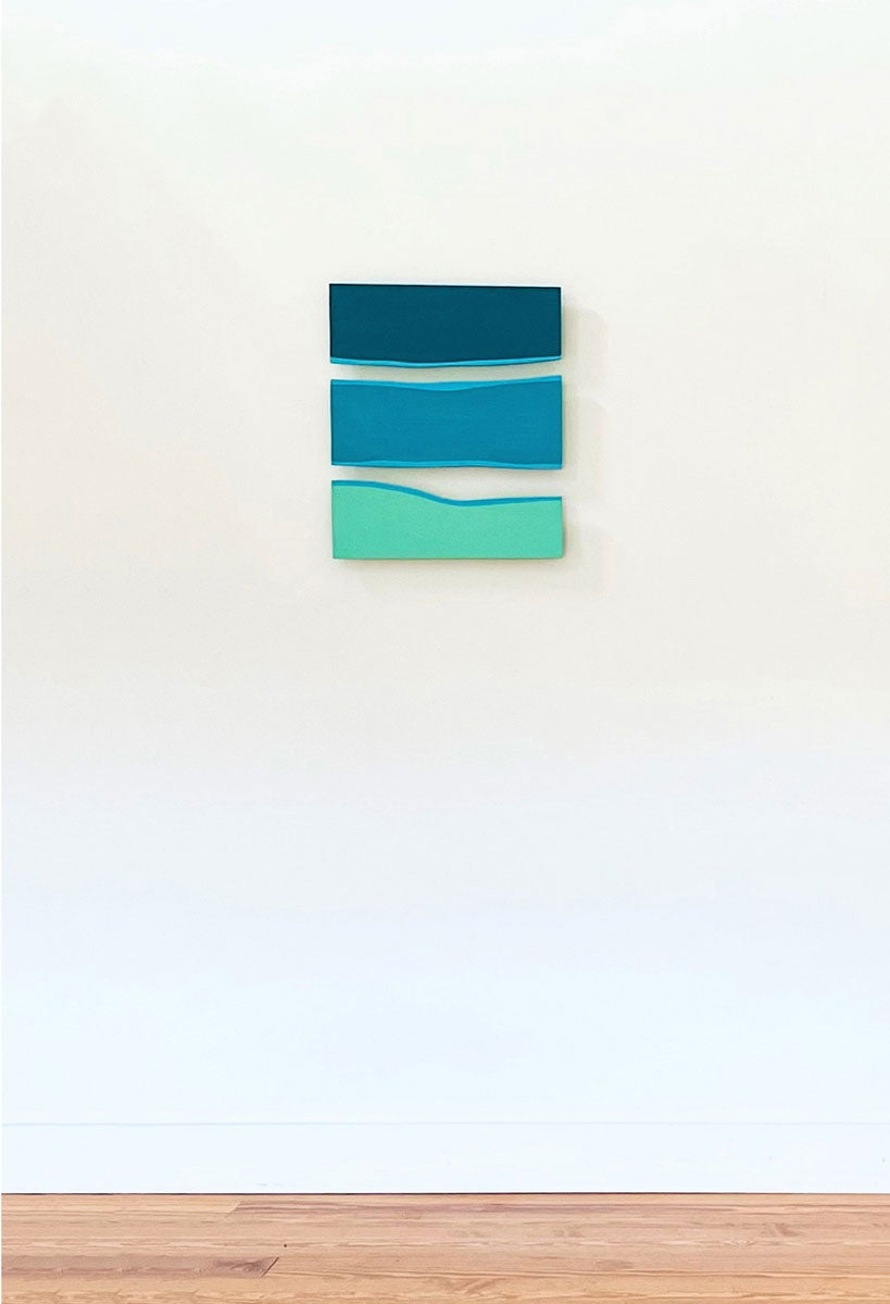 A square-shaped abstract artwork featuring overlapping panels of blue, green, and white colors on a white background.