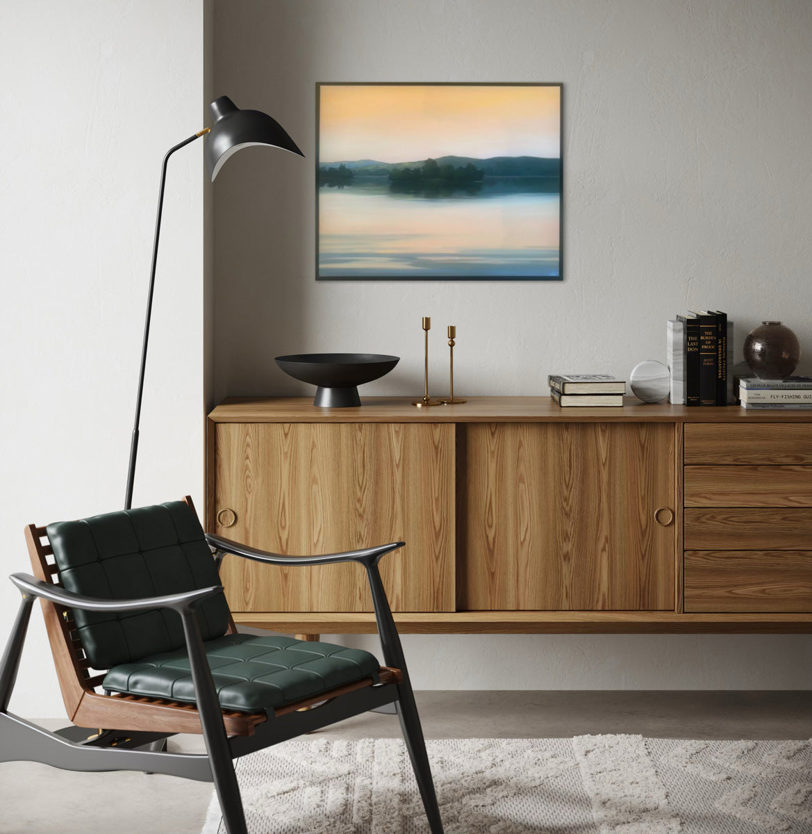 Modern living room with wooden sideboard, black chair, and wall art.