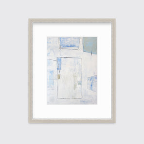 A white, blue and green abstract print in a silver frame with a mat hangs on a white wall.