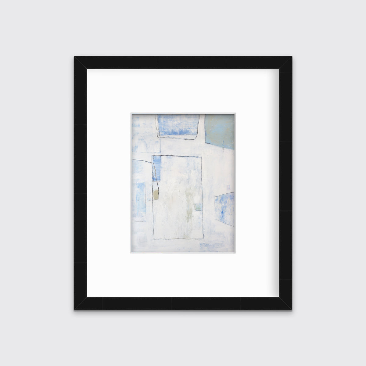 A white, blue and green abstract print in a black frame with a mat hangs on a white wall.