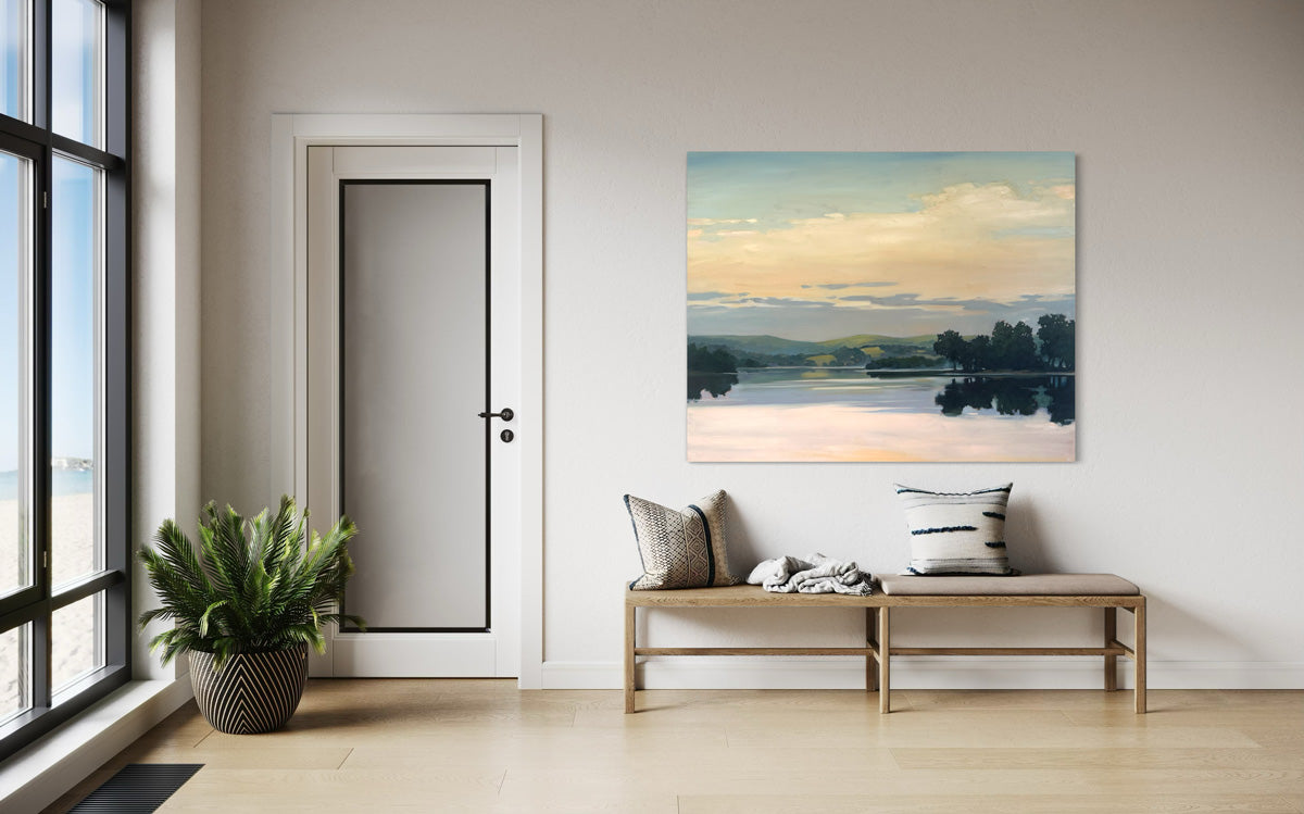 Modern interior with a bench, plant, and original painting of a landscape above the bench.