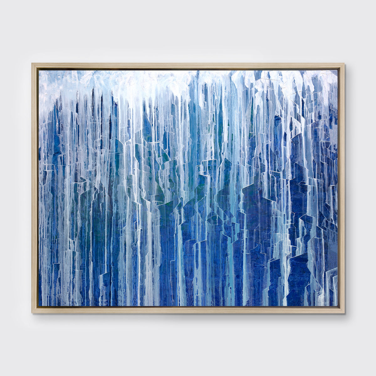A blue and white oak abstract print in a white floater frame hangs on a white wall.
