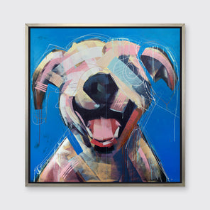 A yellow-orange, pink, red and blue abstract dog print in a silver floater frame hangs on a white wall.