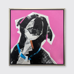 A pink, black, white and blue abstract dog print in a silver floater frame hangs on a white wall.