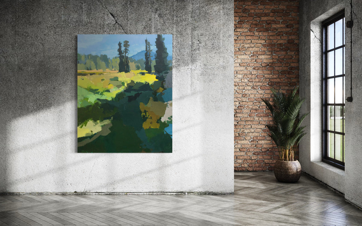 An abstracted blue and yellow painting hangs on a white cement wall.