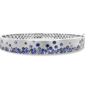 Silver headband with blue gemstones on a white background