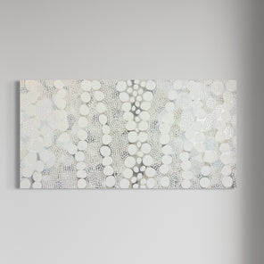 A white, grey, and silver abstract painting hangs on a white wall.