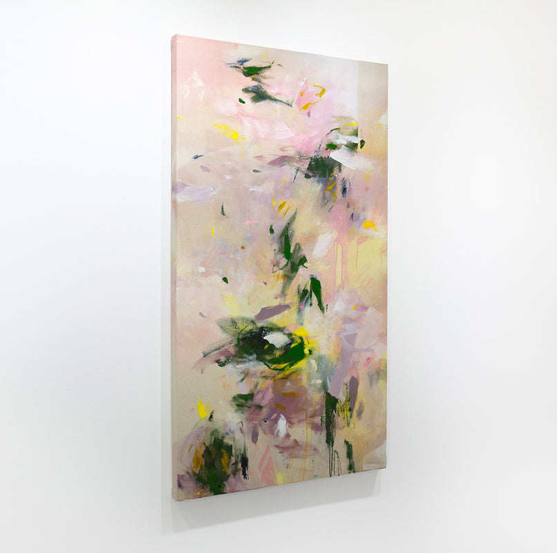 A pink and green abstract painting hangs on a white wall.