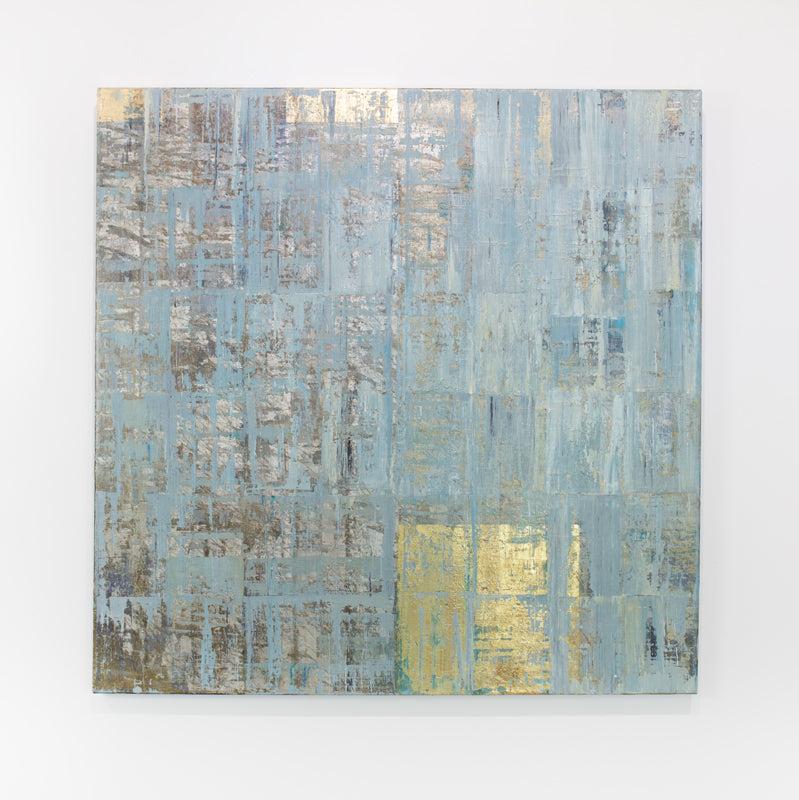 A blue and gold abstract painting hangs on a white wall.