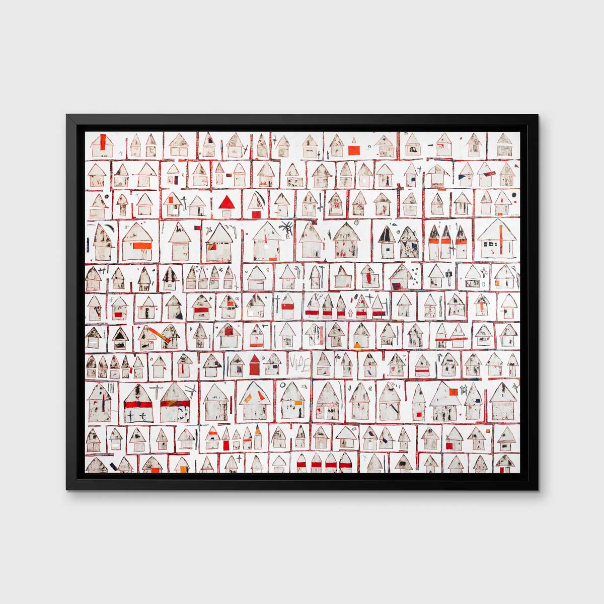 A red and white abstract house print in a black floater frame hangs on a white wall.