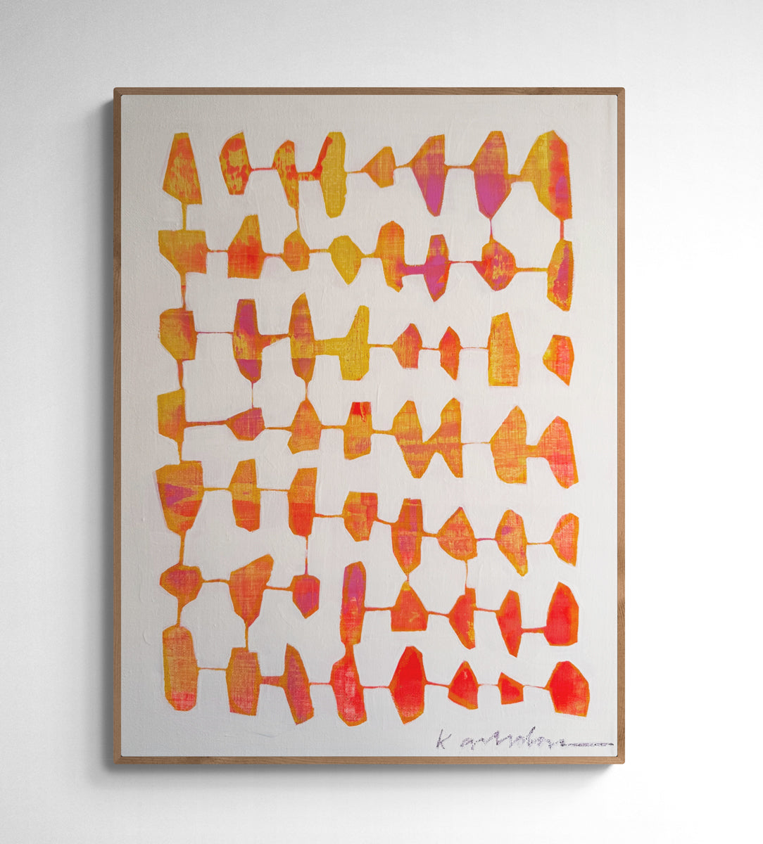 Framed abstract art print with geometric pattern on a white wall.