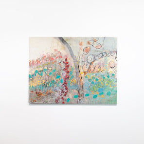 An abstract multicolored painting hangs on a white wall. 